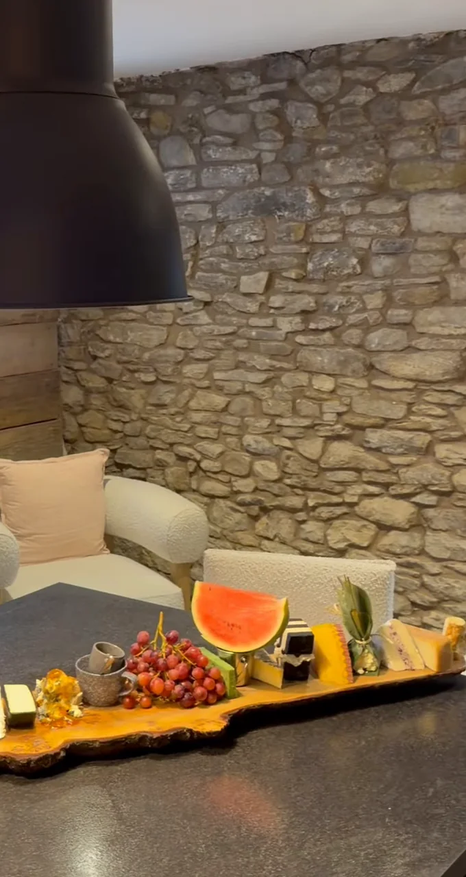 A long sharing board laid out in the stone-walled party room