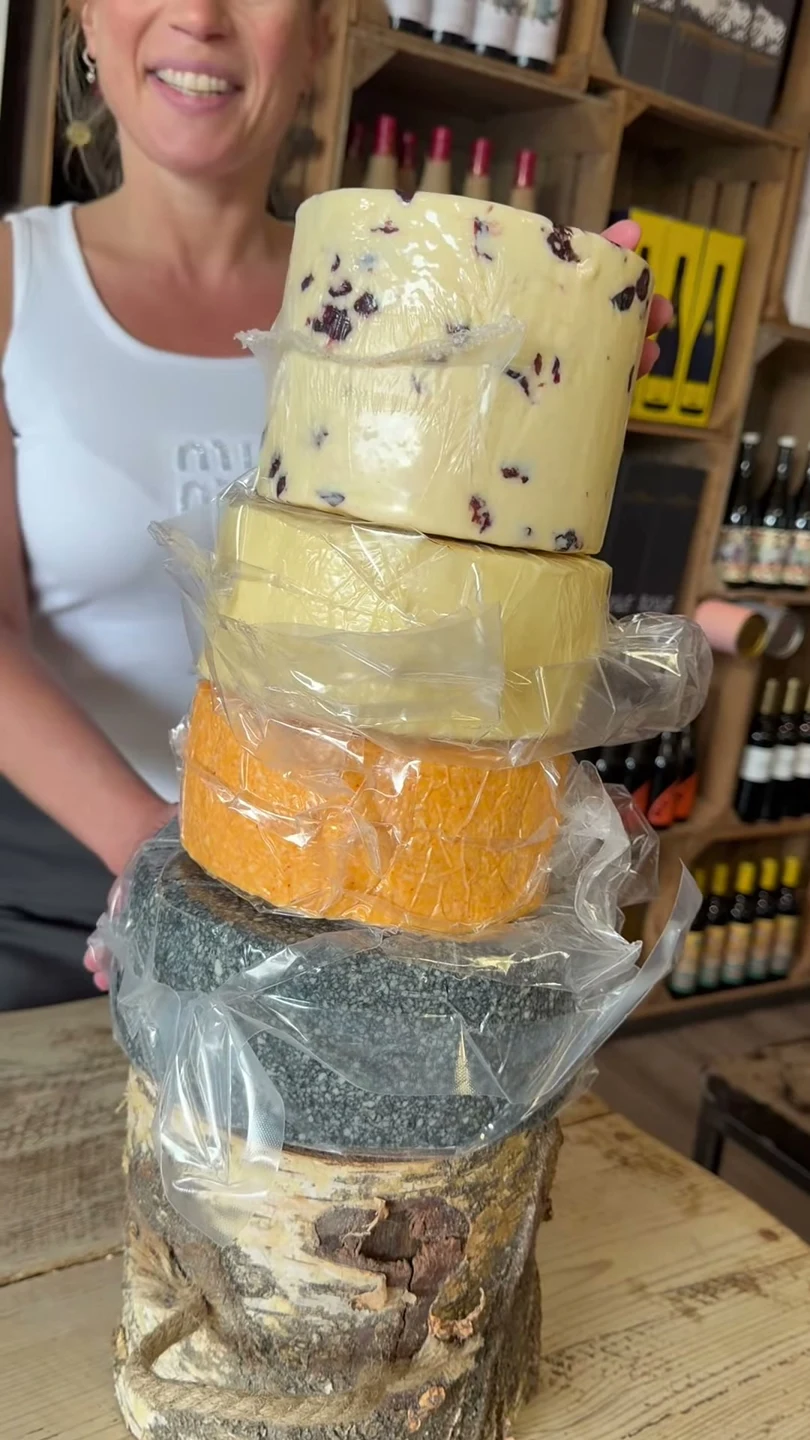 A tower of artisan cheese wheels prepared for a celebration