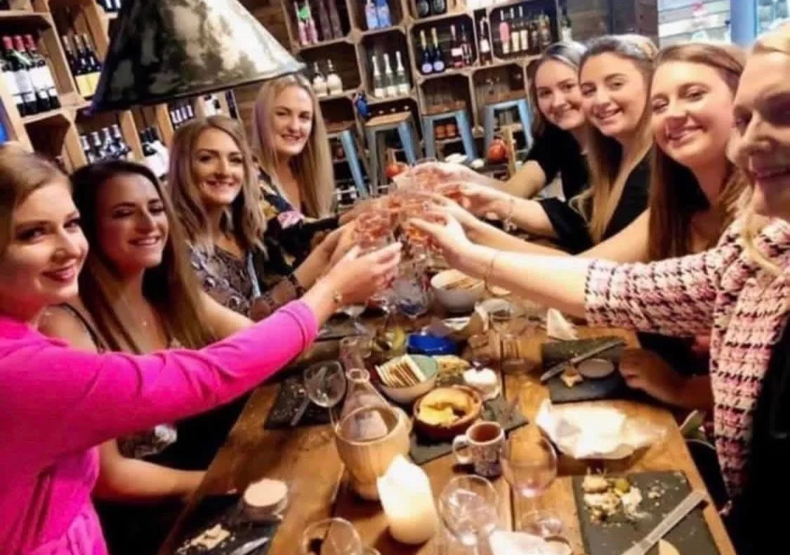 Friends raising a toast in the private cellar
