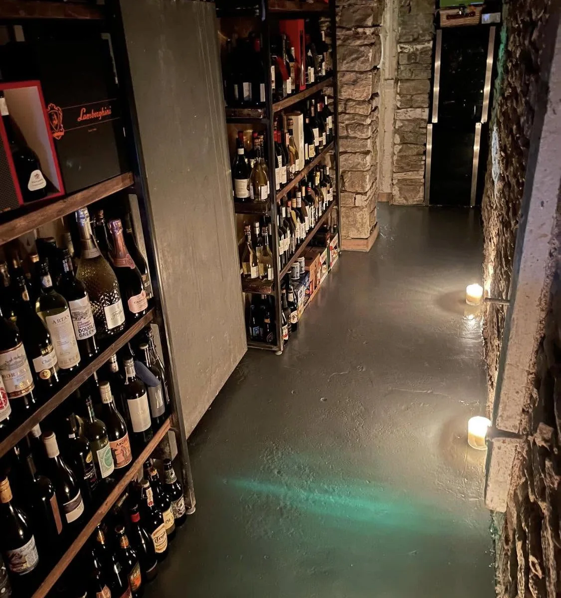 The candlelit Tipsy Cows cellar, lined with racks of wine
