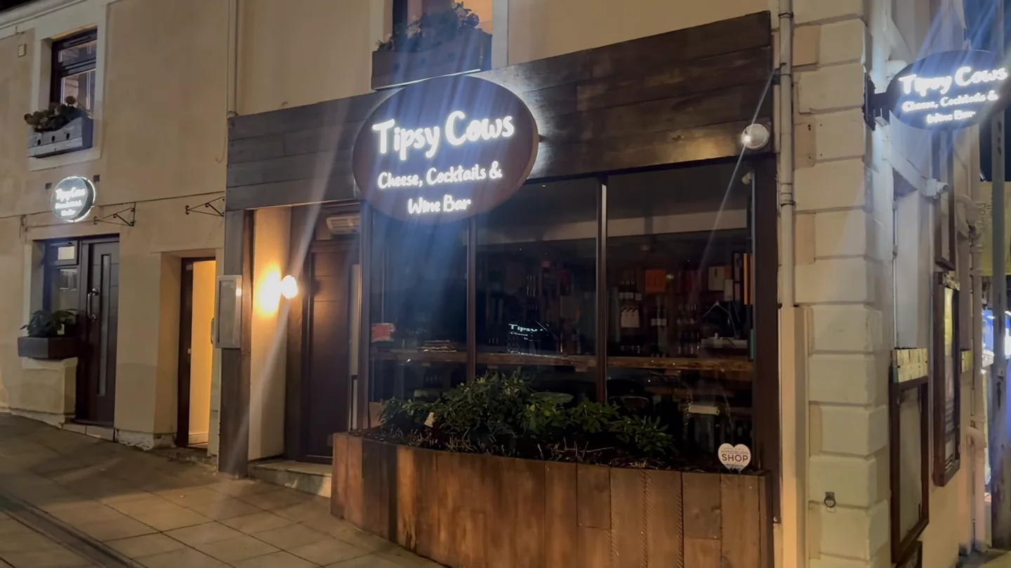 The Tipsy Cows shopfront on Church Street lit up at night